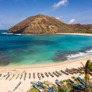Idyllic Mawun beach in the Kuta area of south Lombok in Indonesia with traditional fisherman boats.